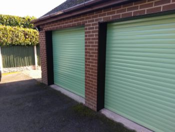 Aluroll insulated roller garage doors in sage green.